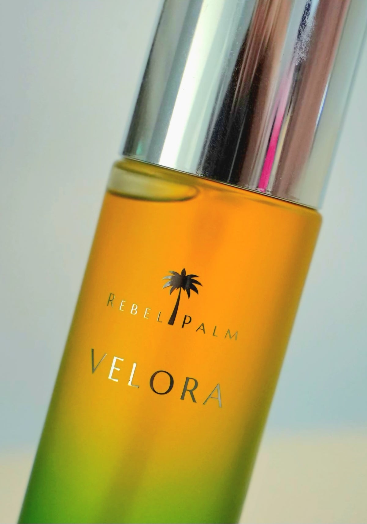 Close-up of Rebel Palm Velora Night Body Oil label on gradient glass bottle