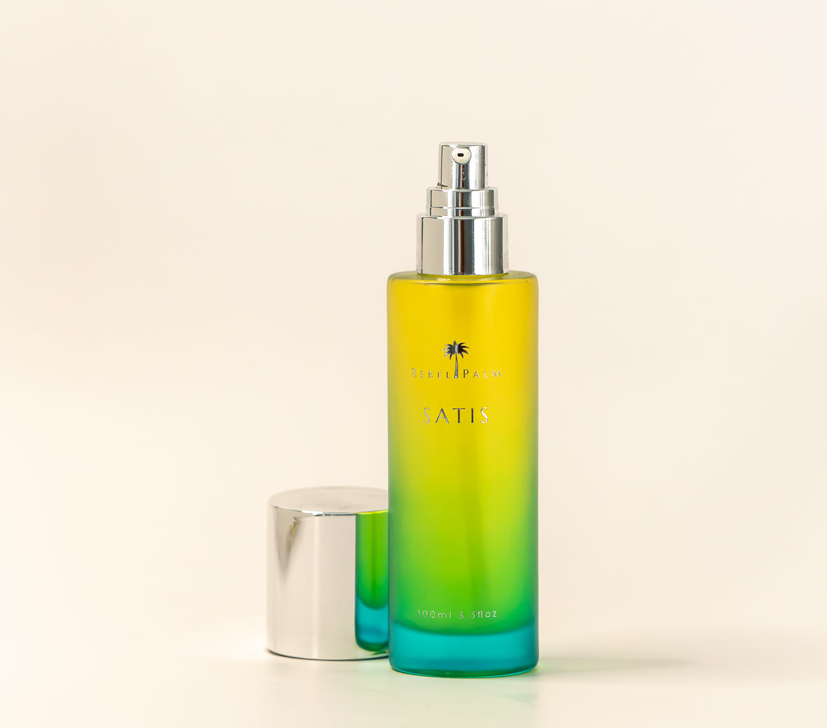 Rebel Palm Satis Post-Shower Body Oil pump bottle with silver cap removed, 100ml